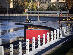 A sign of the season: Crews were out with a large crane to lift the Rideau Canal Skateway changing and washroom facilities onto the canal Saturday, November 6, 2021.