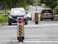 Flex stakes to slow traffic are shown on Sherwood Drive this past summer.