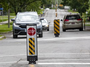 Flex stakes to slow traffic are shown on Sherwood Drive this past summer.