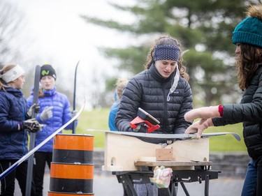 A group of volunteers, Nepean High School students and parents gathered in the Remic Rapids Park parking lot to clean up and wax donated cross-country skis. Rebecca Czerny waxing a ski Sunday afternoon.