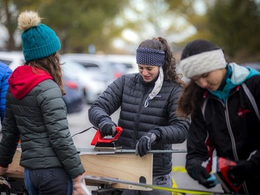 A group of volunteers, Nepean High School students and parents gathered in the Remic Rapids Park parking lot to clean up and wax donated cross-country skis that will be for the Kichi Sibi Winter Trail's Skis for Schools program, Sunday, November 14, 2021.