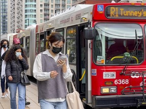 FILE PHOTO: OC Transpo R1 buses operating on Rideau Street adjacent to the Rideau LRT Station.