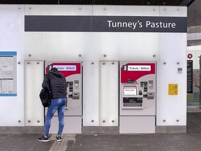 A passenger buys a ticket at the Tunney's Pasture Station on Nov. 12, the first day of the resumption of LRT service after September's derailment.