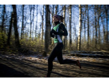A competitor in the under-20 women's six-kilometre race runs through the woods of Wesley Clover Parks on Saturday.