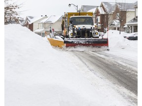 A snowplow clears the roads during an Ottawa storm. Sidewalks are a secondary concern.