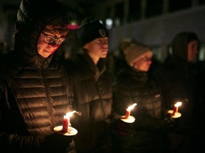 People attend a vigil Nov. 22, 2021 in Waukesha, Wisconsin, in a park close to where five people were killed and dozens injured after an SUV plowed through a holiday parade on Nov. 21.