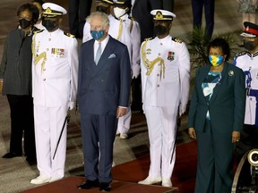 BRIDGETOWN, BARBADOS - NOVEMBER 28: Prince Charles, Prince of Wales is greeted by Dame Sandra Mason (in green) as he arrives at Bridgetown Airport on November 28, 2021 in Bridgetown, Barbados. The Prince of Wales arrived in the country ahead of its transition to a republic within the Commonwealth.