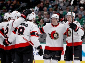 Drake Batherson #19 of the Ottawa Senators and Brady Tkachuk #7 of the Ottawa Senators celebrate with Josh Norris #9 of the Ottawa Senators after Norris scored against the Dallas Stars in the second period at American Airlines Center on October 29, 2021 in Dallas, Texas.