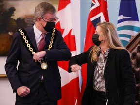 Mayor Jim Watson attends the official swearing-in of the new Kanata-North councillor, Cathy Curry (right), on Nov. 12.
