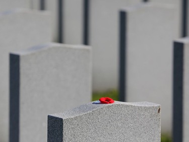 A poppy was left on a  tombstone of a soldiers in the National Military Cemetery after the Remembrance Day ceremonies at the National Military Cemetery at the Beechwood Cemetery in Ottawa, November 11, 2021.