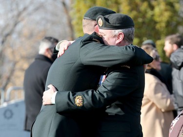 Members of the military greet each other after the Remembrance Day ceremonies at the National Military Cemetery at the Beechwood Cemetery in Ottawa, November 11, 2021.