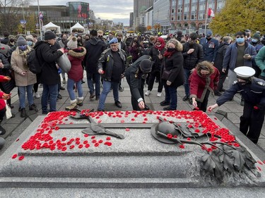 OTTAWA -- People place poppies on the Tomb of the Unknown Soldier following Remembrance Day services at the National War Memorial on Thursday, November 11, 2021. -- . ERROL MCGIHON, Postmedia