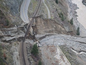 Railway tracks are suspended above the washed out on an underpass of the Trans Canada Highway 1 after devastating rain storms caused flooding and landslides, northeast of Lytton, British Columbia, Canada November 17, 2021. Picture taken November 17, 2021.