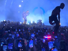A man jumps on an ambulance standing in the crowd during the Astroworld music festiwal in Houston, Texas, U.S., November 5, 2021 in this still image obtained from a social media video on November 6, 2021.