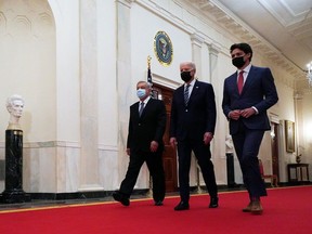 U.S. President Joe Biden (C), Canadian Prime Minister Justin Trudeau (R) and Mexican President Andres Manuel Lopez Obrador (L) walk through the Cross Hall prior to the first North American Leaders’ Summit (NALS) since 2016 at the White House November 18, 2021 in Washington, DC.