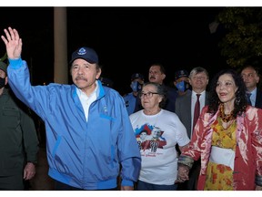 This photo released by the Nicaraguan presidency shows President Daniel Ortega (l) waving at supporters in Managua on Nov. 8, as his wife and Vice-President Rosario Murillo (r) looks on. His re-election took place with almost every opposition candidate in prison.