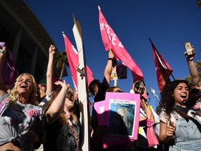 Fans of Britney Spears react with joy following the ending of her conservatorship, outside the Stanley Mosk courthouse in Los Angeles, California on November 12, 2021.