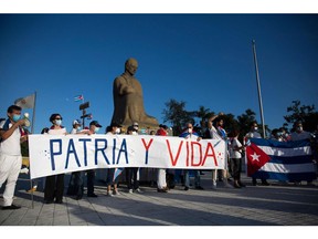 Cubans living in the Dominican Republic demonstrate in support of the Cuban opposition in front of Jose Marti Park in Santo Domingo, on Nov. 15, 2021.