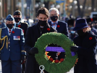 Canada's Prime Minister Justin Trudeau and his wife Sophie Gregoire hold a wreath of flowers during a ceremony at the National War Memorial on Remembrance Day in Ottawa.