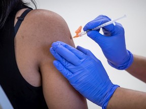 A woman receives a dose of the Pfizer COVID-19 vaccine.