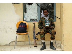 A soldier with the Tigrayan forces reads a book as he guards a building in Mekelle, the capital of Tigray region, Ethiopia.
