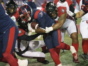Alouettes running back William Stanback is tackled by Redblacks defensive lineman Davon Coleman during the first quarter of Friday's game in Montreal. Coleman would later have two fumble recoveries.