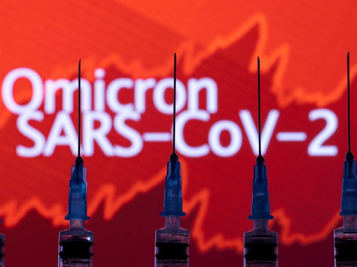  Syringes with needles are seen in front of a displayed stock graph and words “Omicron SARS-CoV-2” in this illustration taken on Saturday.
