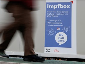 A man walks past a vaccination point amidst the coronavirus disease (COVID-19) outbreak, as Austria's government imposes a lockdown on people who are not fully vaccinated, in Vienna, Austria November 14, 2021.