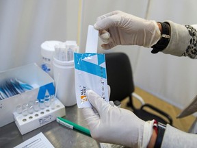 A medical specialist demonstrates a test at a COVID-19 rapid testing centre located at a metro station amid the outbreak of the coronavirus disease in Moscow, Russia November 9, 2021.