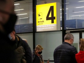 People wait at the arrivals area inside Schiphol airport after Dutch health authorities said that 61 people who arrived in Amsterdam on flights from South Africa tested positive for COVID-19, in Amsterdam, Netherlands, November 27, 2021. REUTERS/Eva Plevier