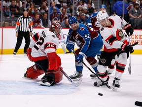 Colorado Avalanche left wing Gabriel Landeskog (92) and Ottawa Senators defenceman Artem Zub (2) battle for the puck as goaltender Filip Gustavsson (32) defends in the second period at Ball Arena, November 22.