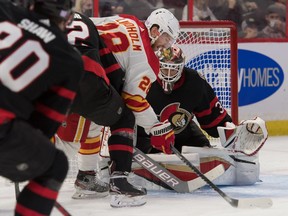 Calgary Flames centre Elias Lindholm (28) skates with the puck in front of Ottawa Senators goalie Anton Forsberg (31) in the first period at the Canadian Tire Centre.