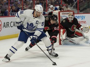 Toronto Maple Leafs center John Tavares (91) skates with the puck in front of  Ottawa Senators defenceman Nikita Zaitsev (22) in the first period at the Canadian Tire Centre.