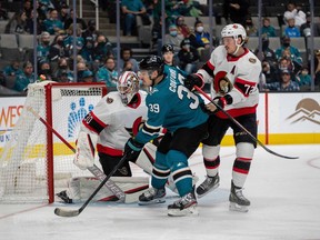 Nov 24, 2021; San Jose, California, USA;  San Jose Sharks center Logan Couture (39) battles for position in front of the net against Ottawa Senators defenseman Thomas Chabot (72) during the second period at SAP Center at San Jose.