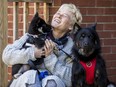 A very happy Christina Kennis with her dogs Chloe and pup Bella, who recently returned from Cuba.