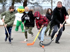 Former Ottawa Senator Chris Neil played some hockey with kids from Henry Munro Middle School on the outdoor rink at the Eastvale Park in Ottawa Wednesday.