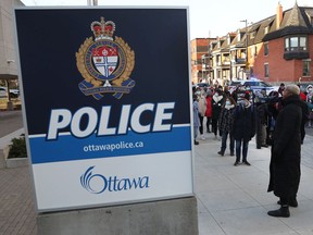 Community organizations and other members of the public rallied outside Ottawa Police Service headquarters on Elgin Street before the police services board vote on the proposed budget Increase on Tuesday.