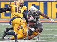 Queen's Gaels Stephane East (15) moves in to tackle Ottawa Gee-Gees Dawson Odei during Ontario University Athletics east final football action at Richardson Stadium on Saturday, Nov. 13, 2021.