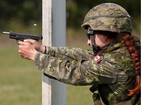 A 2012 file photo shows a Canadian firing a Browning Hi Power pistol in the Canadian Armed Forces Small Arms Concentration at Connaught Ranges in Ottawa