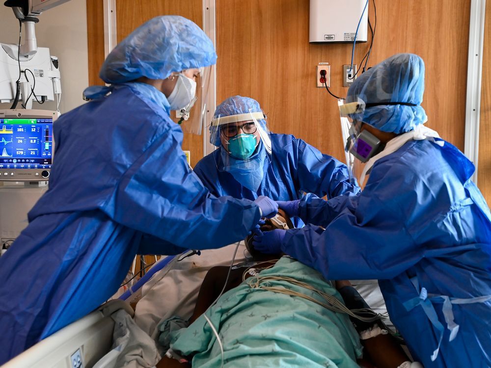 Head intensivist Dr. Ali Ghafouri, centre, provides life saving medical care in an emergency situation in the intensive care unit at the Humber River Hospital during the COVID-19 pandemic in Toronto on Tuesday, April 13, 2021