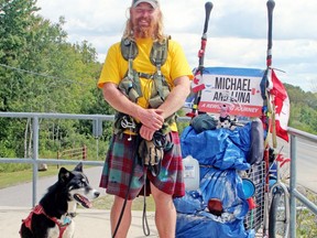 Michael Yellowlees and Luna paused for a break on their cross-Canada walk at the lookout on Highway 17 west of North Bay, Thursday, Sept. 9.