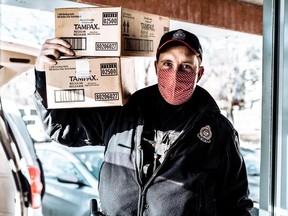 Const. Seb Lemay, a community police officer for Lowertown, with boxes of supplies for the Purse Project.