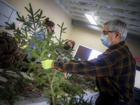 Volunteers gathered to help build wreaths at the Memorial Cross Building at Beechwood Cemetery on Saturday, December 4, 2021, after wreaths destined for the National Military Cemetery were stolen.