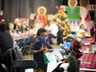 Six-year-old Mayson Hodgins-Small decorates his Christmas tree.