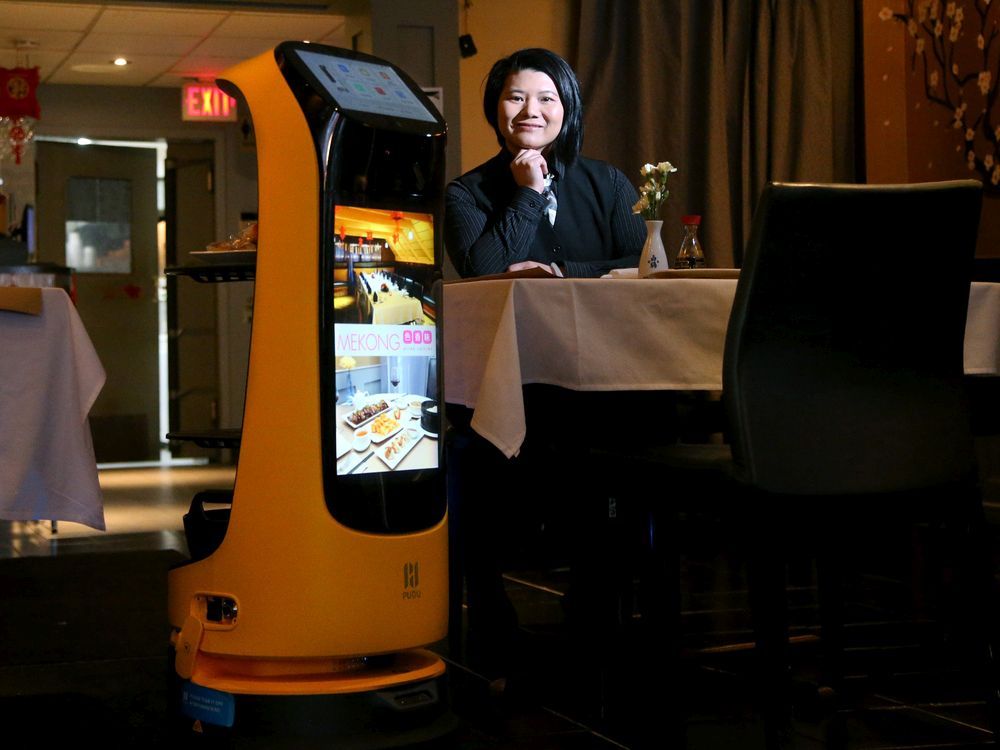 Mekong owner Winnie Zhang shows off the restaurant's newest waiter — a robot called KettyBot that delivers dishes to patrons at their table and can even sing Happy Birthday. 
