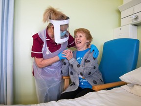 Margaret Keenan, 90, the first patient in the United Kingdom to receive the Pfizer/BioNtech covid-19 vaccine, speaks with Healthcare assistant Lorraine Hill as she prepares to leave University Hospital Coventry & Warwickshire, the day after receiving the first of two doses of the vaccine, on December 9, 2020.