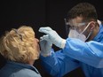 A passenger off an international flight is tested for COVID-19 at Amsterdam Schiphol airport on Dec. 2.