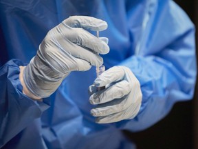 A health worker tests passengers for the Coronavirus at Amsterdam Schiphol airport on December 2, 2021 in Amsterdam, Netherlands.