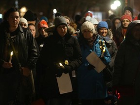 People gather at the Women's Monument at Minto Park on the 30th anniversary of the massacre at l'Ecole Polytechnique.