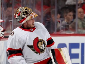 Anton Forsberg (31) of the Ottawa Senators has difficulty with his equipment in the third period against the New Jersey Devils at Prudential Center on Dec. 06, 2021 in Newark, New Jersey.